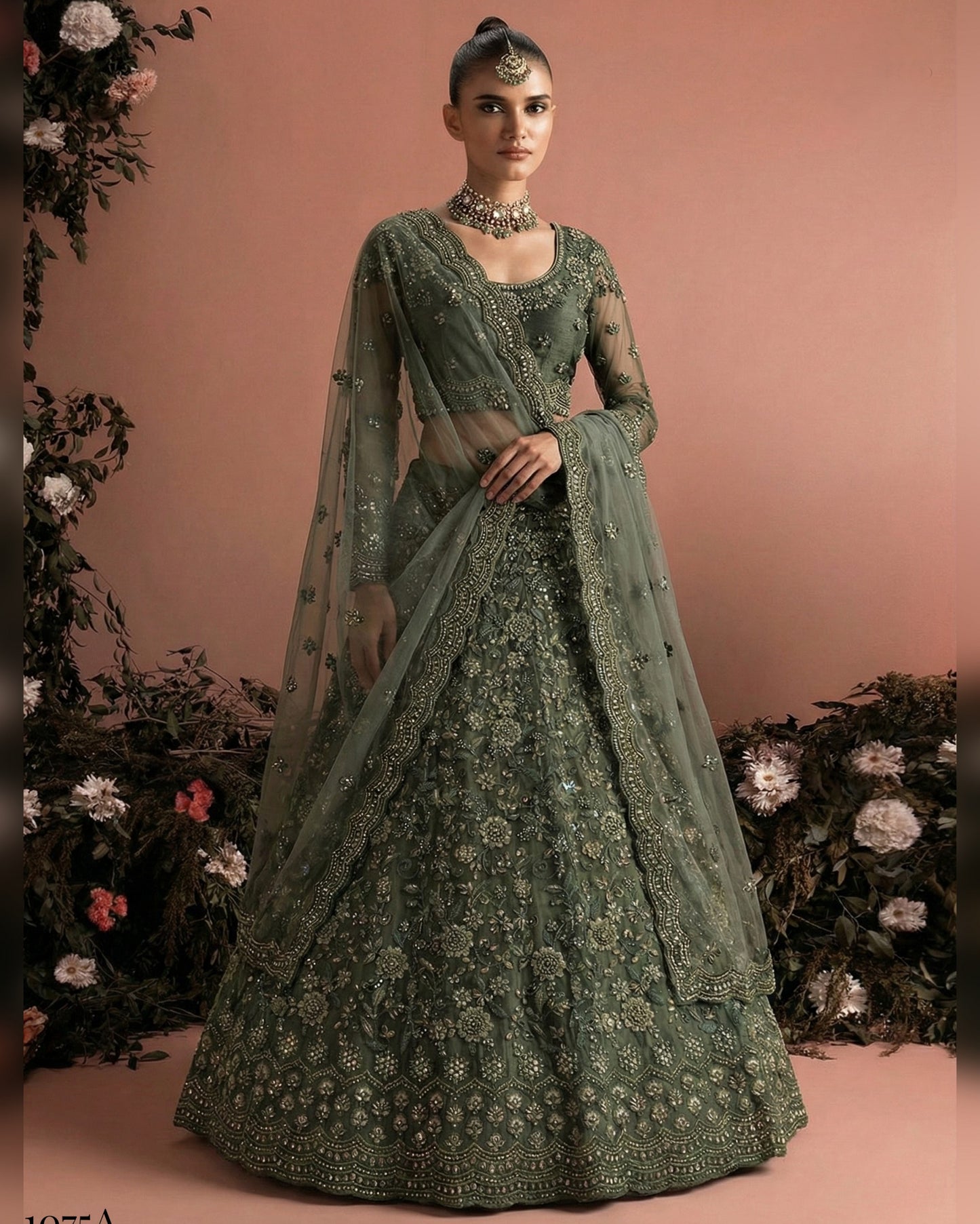Green embroidered traditional outfit with a matching dupatta on a pink background
