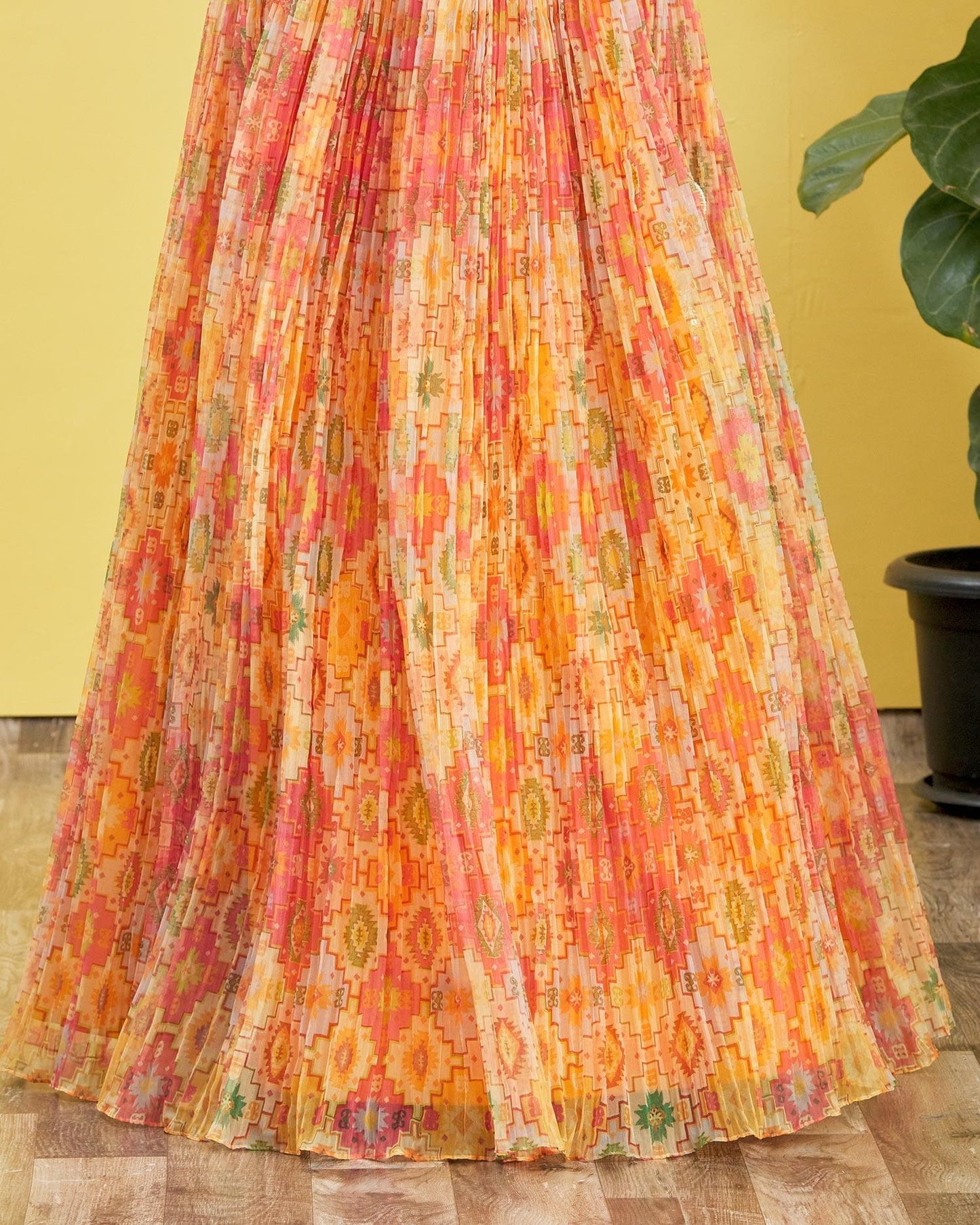 Colorful floral skirt on a wooden floor with a yellow wall background