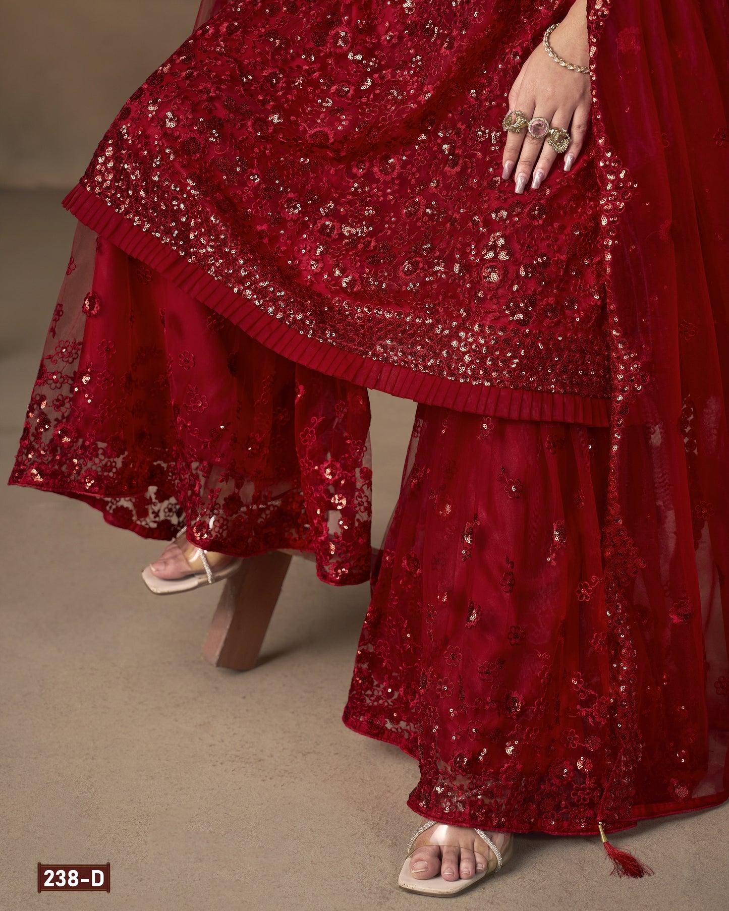Red sequined outfit with a plain background