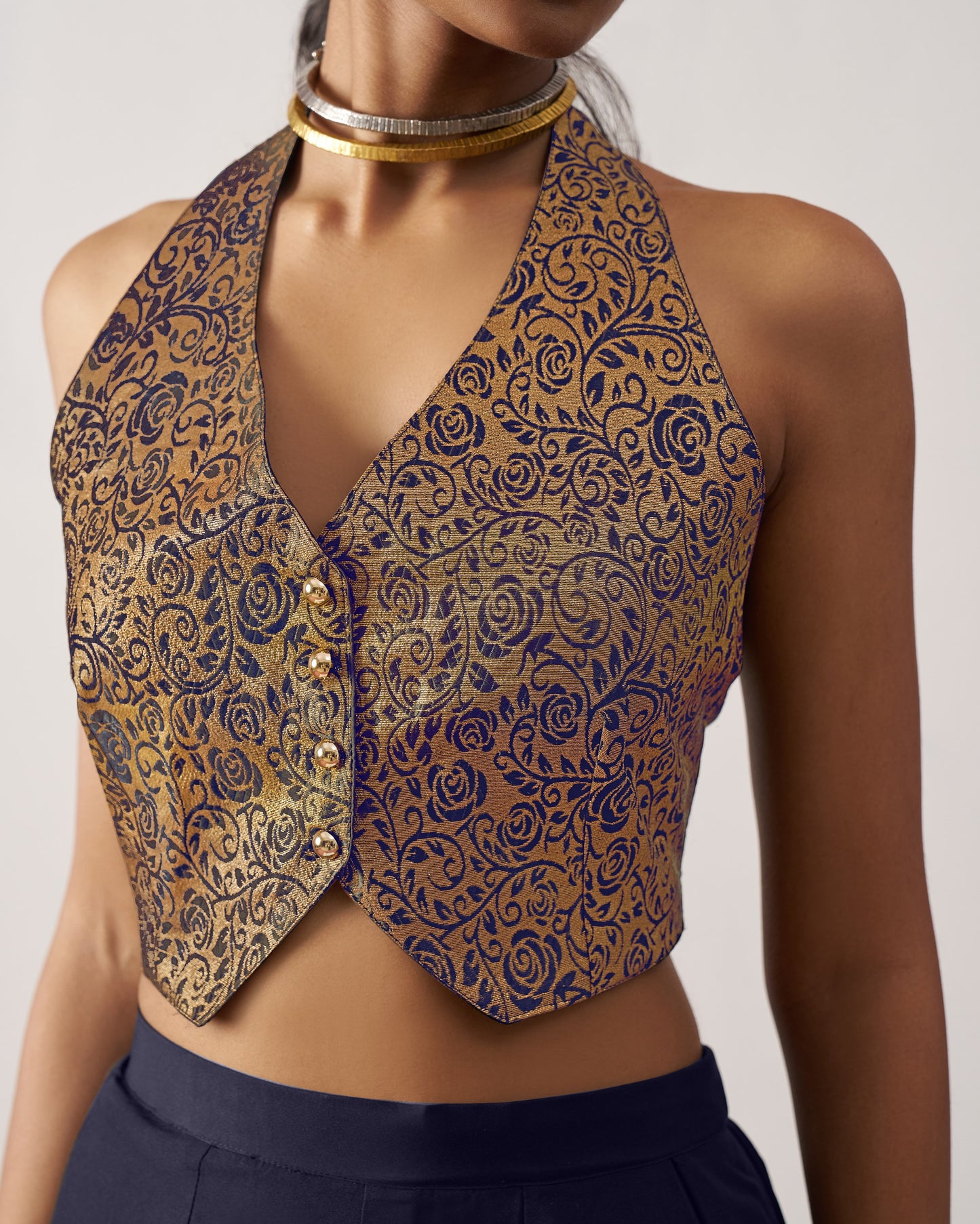 Patterned vest worn by a person on a plain background