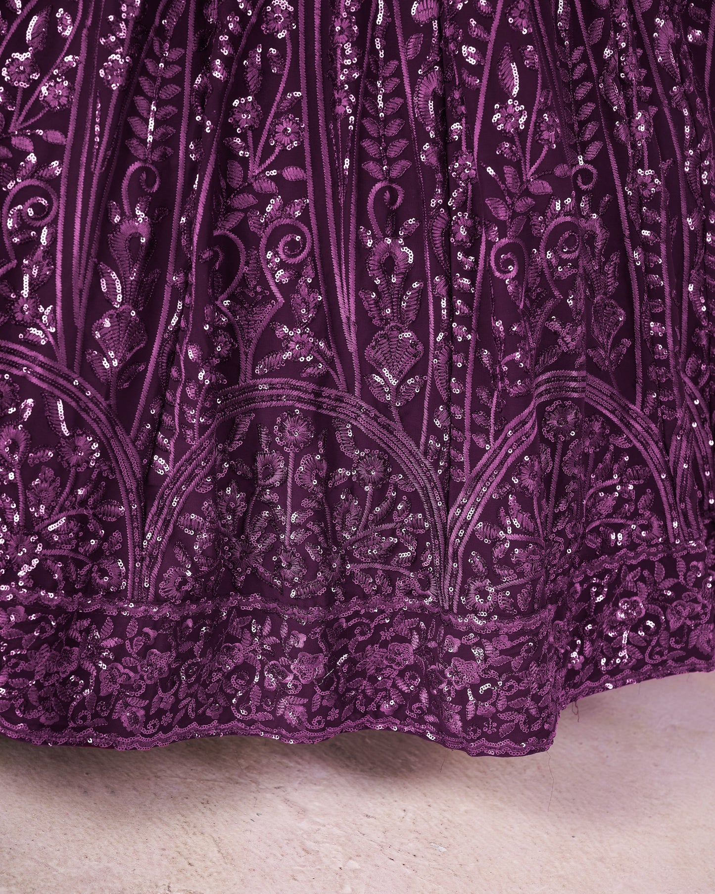 Close-up of a purple sequin fabric with intricate patterns