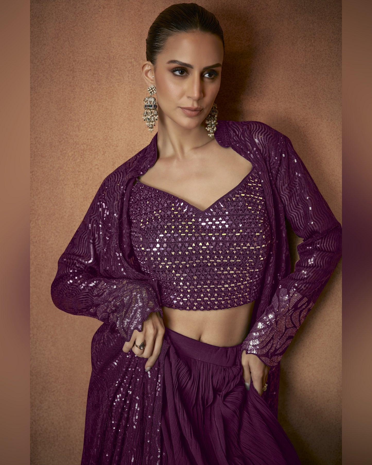 Woman wearing a purple sequined outfit against a brown background