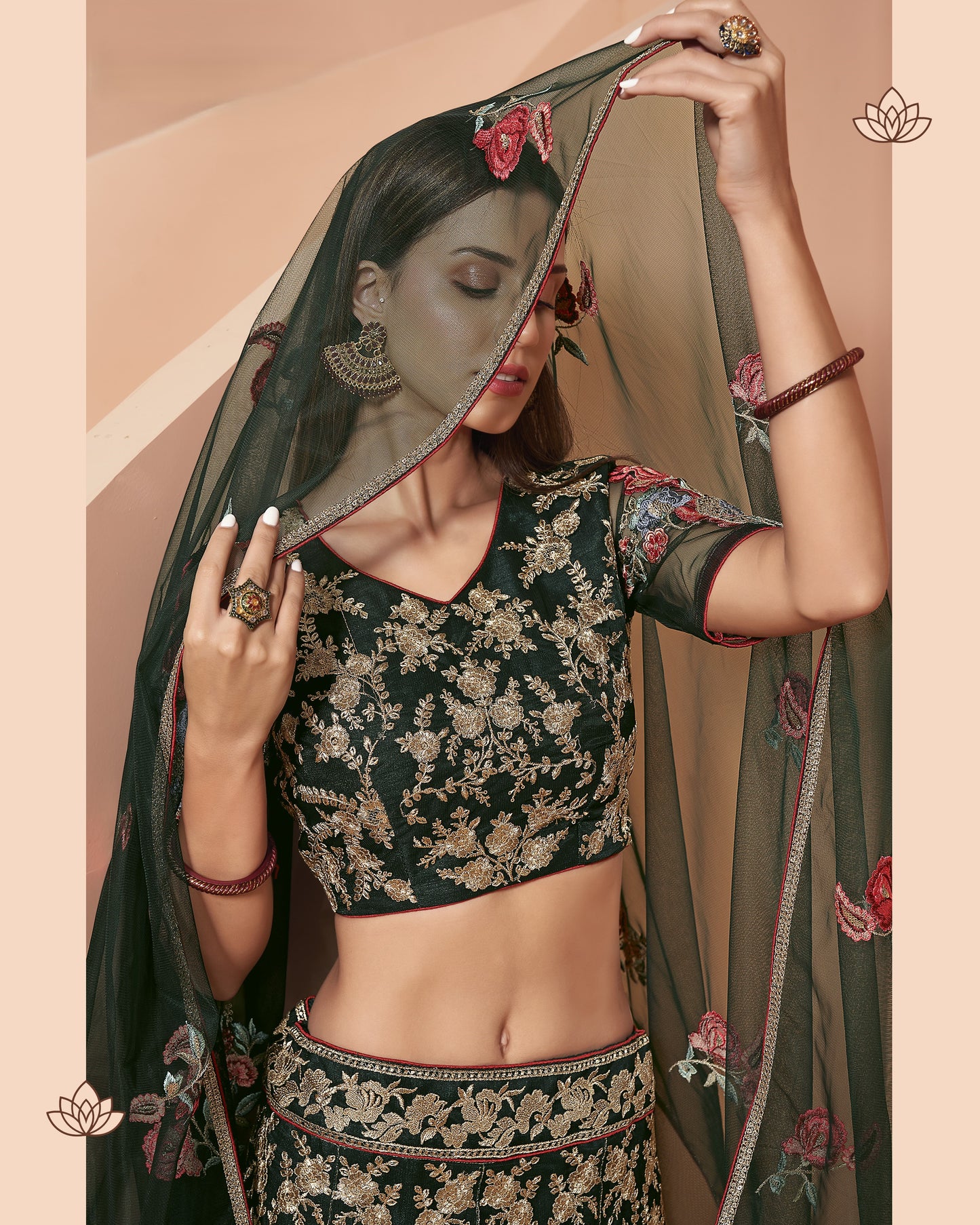 Woman in traditional black floral blouse and saree with a beige background