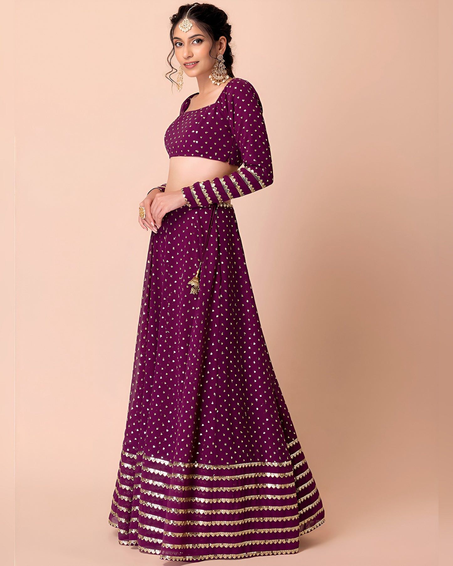 Woman wearing a purple traditional outfit with gold patterns on a beige background