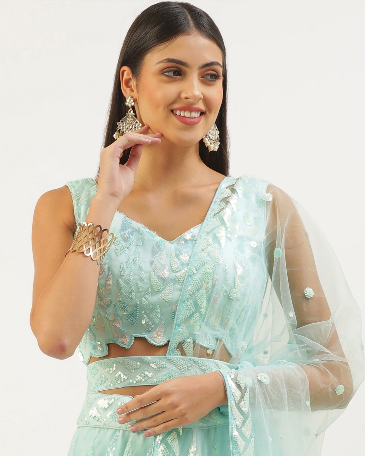 Woman wearing a light blue traditional outfit with a white dupatta against a white background