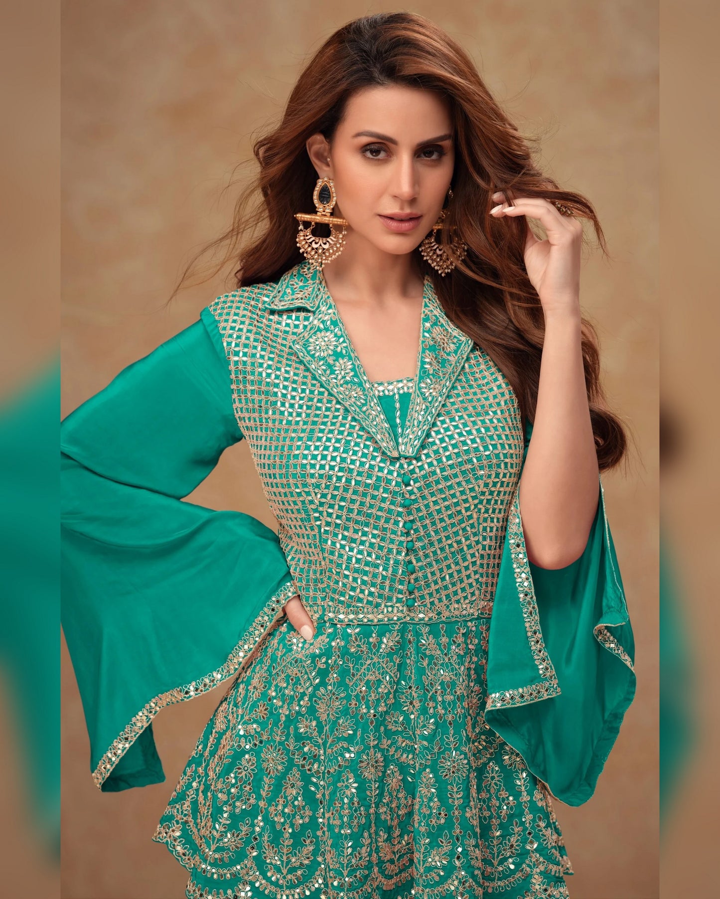 Woman wearing a green traditional outfit with intricate patterns on a beige background