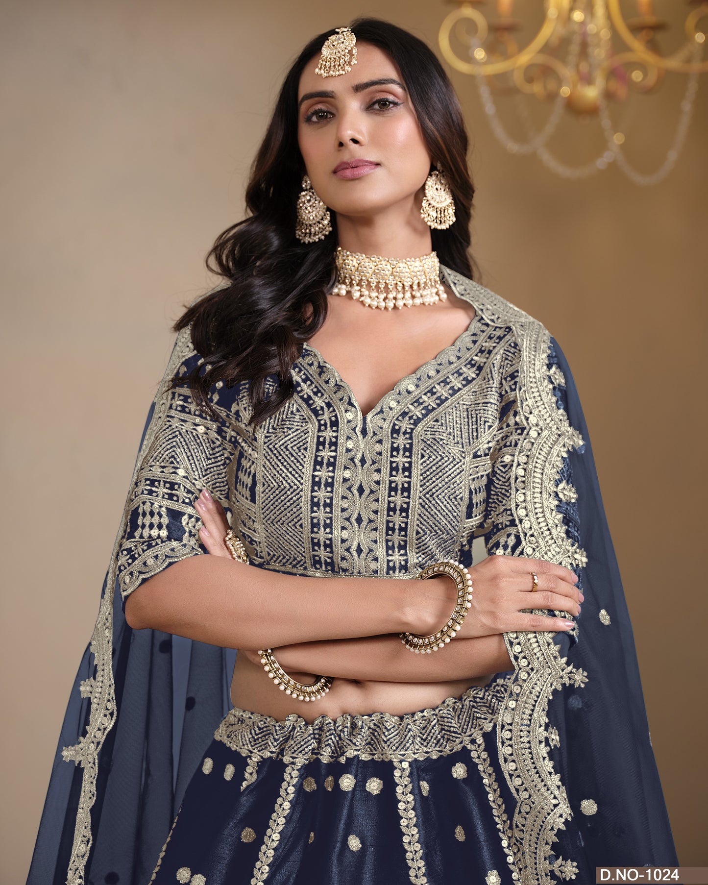 Woman in traditional embroidered outfit with jewelry against a neutral background
