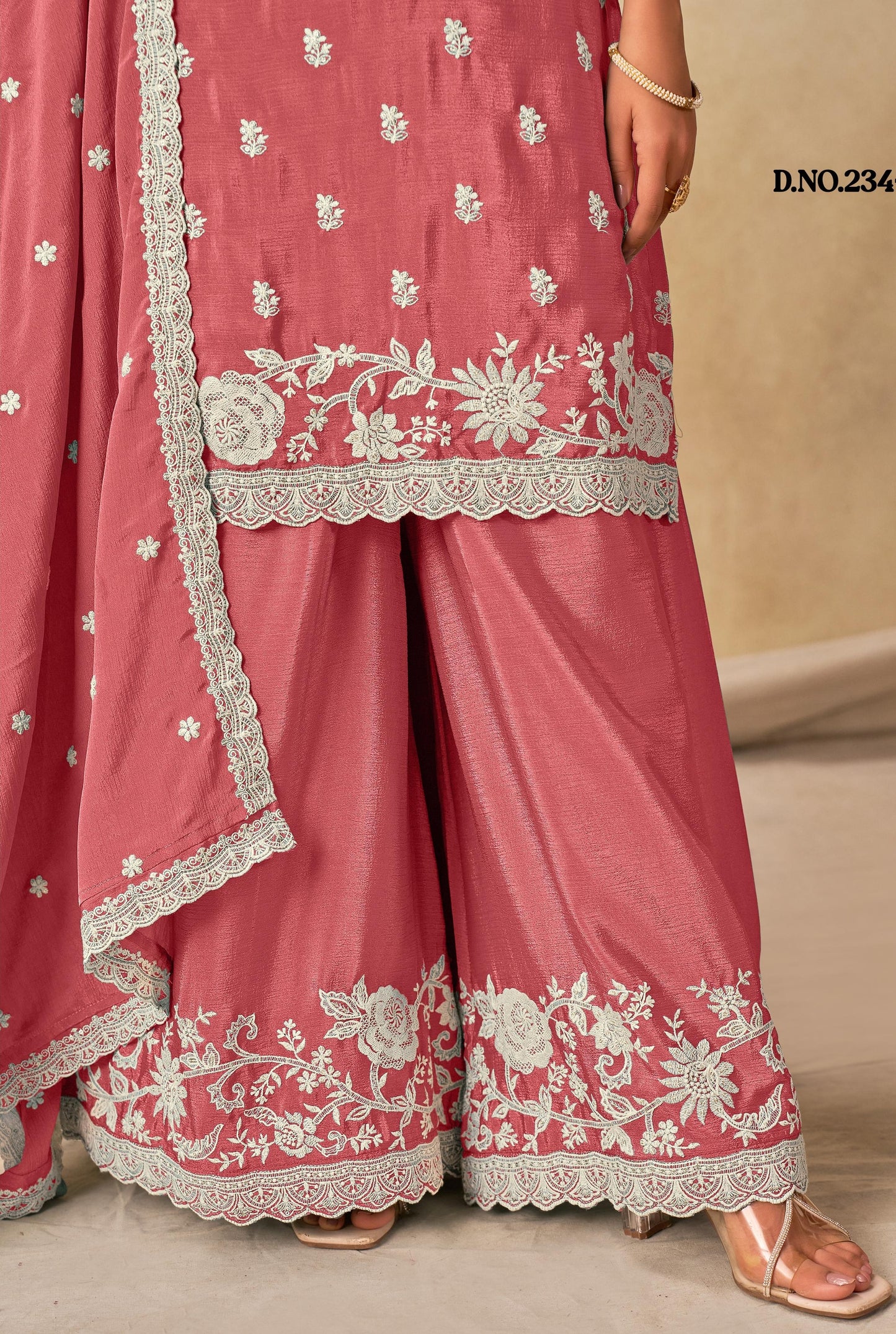 Pink traditional outfit with white floral embroidery on a beige background