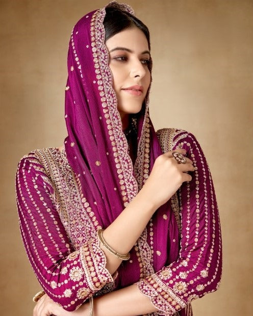 Woman wearing a purple embroidered dupatta against a beige background