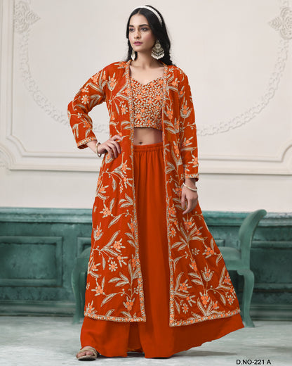 Woman wearing an orange traditional outfit with floral patterns in a decorative setting