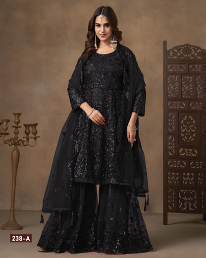 Woman wearing a black traditional outfit with intricate designs against a brown background