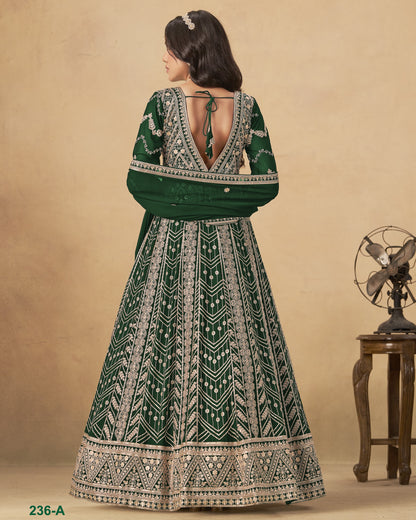Woman wearing a green and white patterned dress with a vintage fan in the background