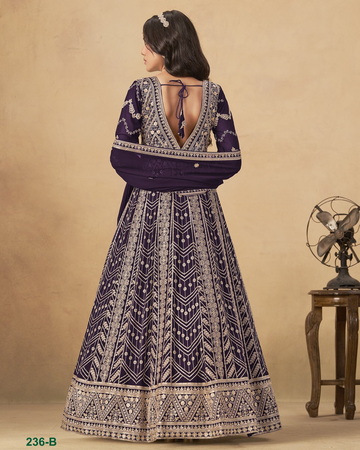 Woman wearing a patterned dress with a beige background