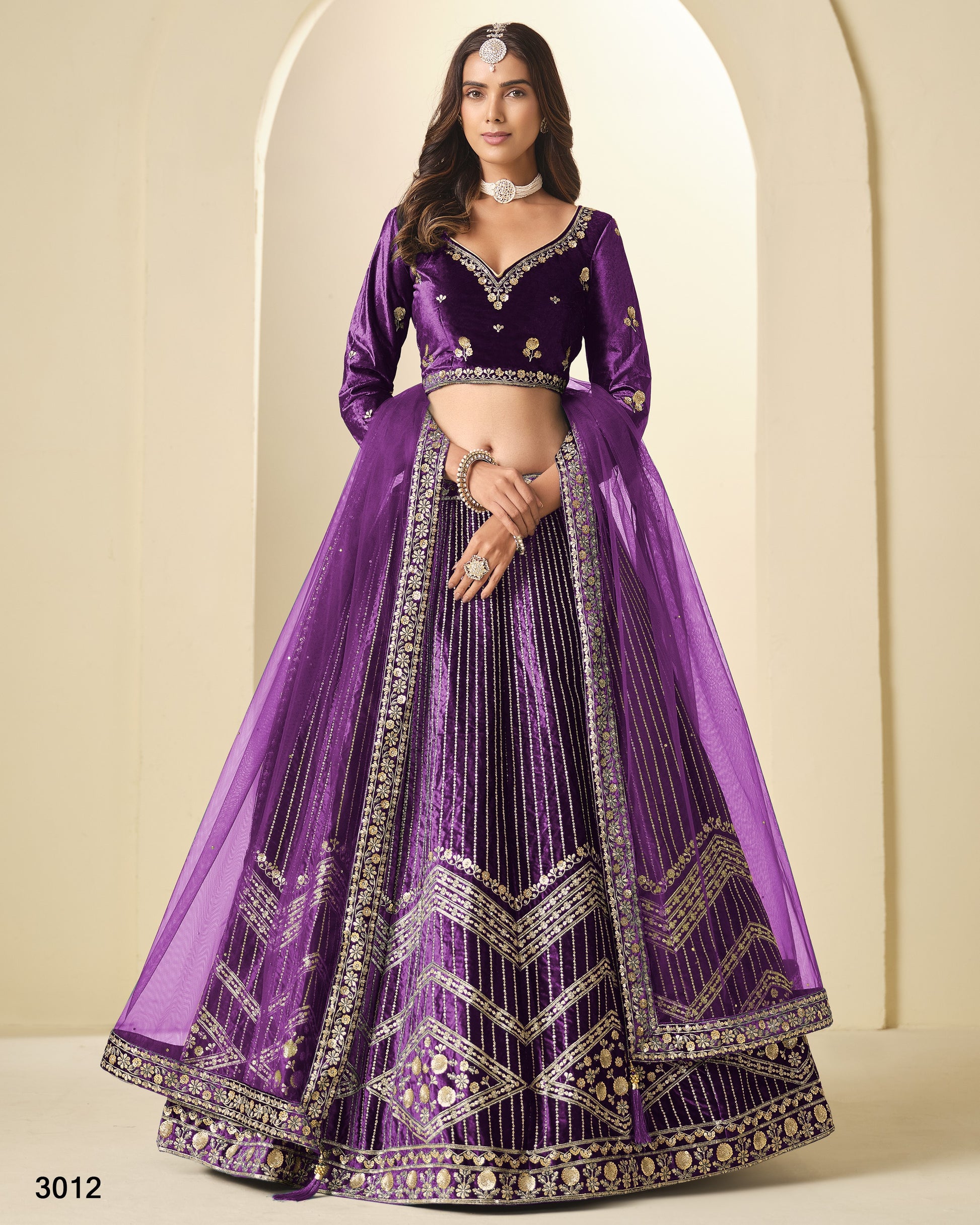 Purple embroidered lehenga with matching blouse on a neutral background
