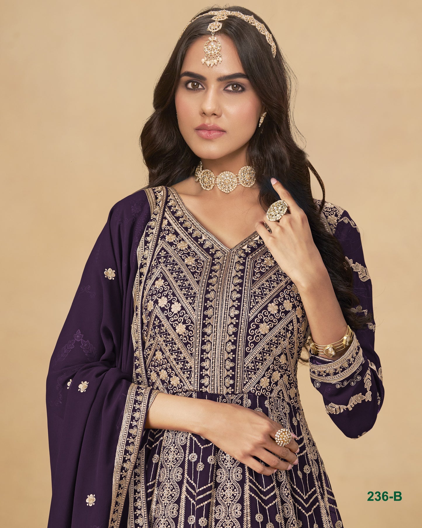 Woman wearing a traditional outfit with intricate patterns on a beige background
