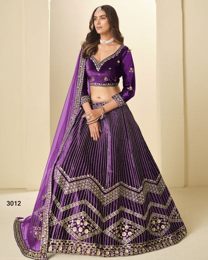 Woman wearing a purple embroidered lehenga with a plain background