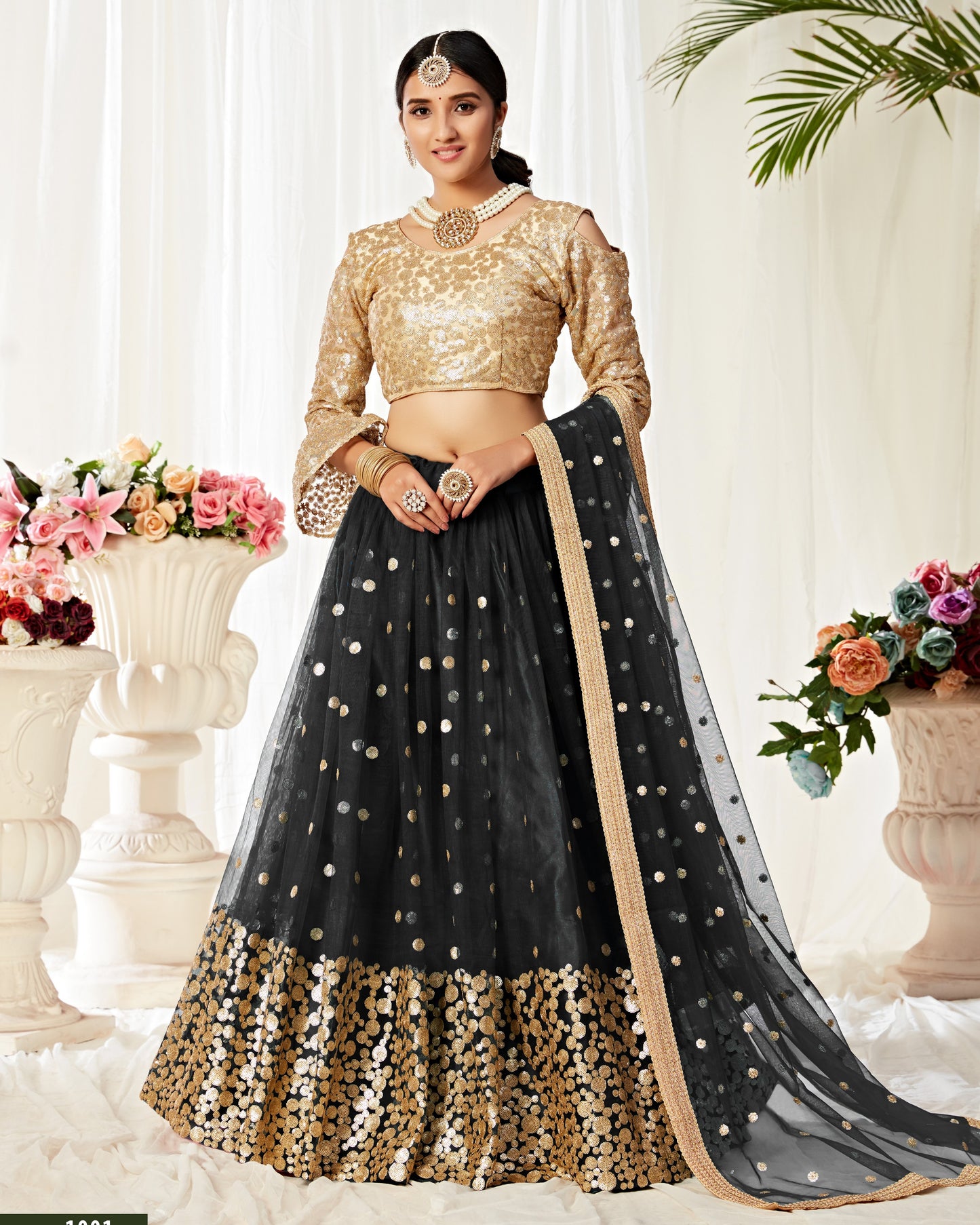 Woman wearing a black and gold traditional outfit with a white background