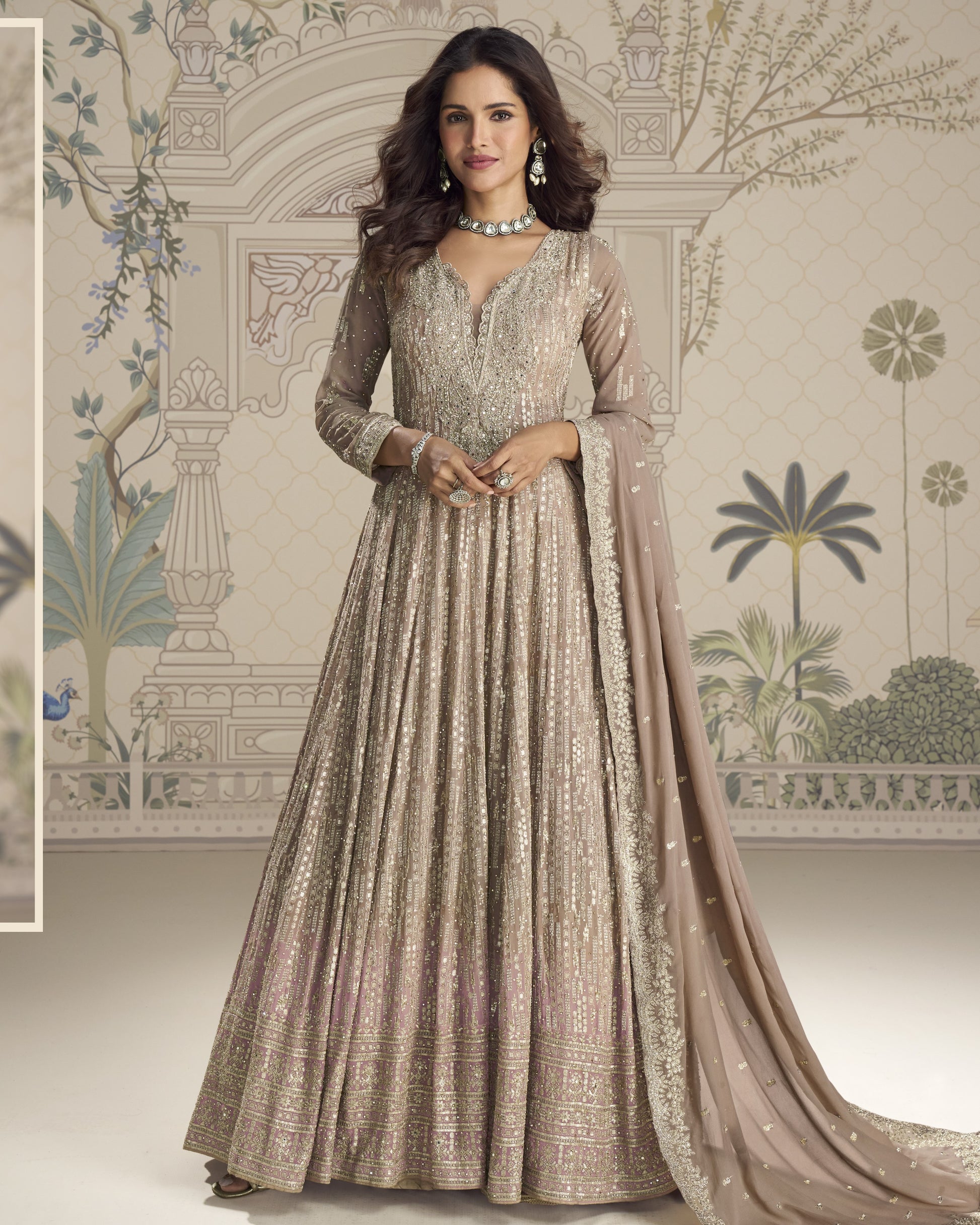 Woman wearing a traditional embroidered gown with a decorative background