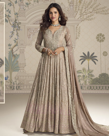 Woman wearing a traditional embroidered gown with a decorative background