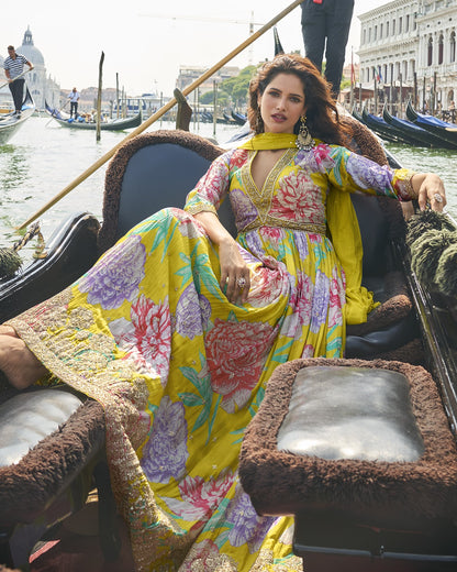 Woman in a colorful floral dress on a gondola in Venice