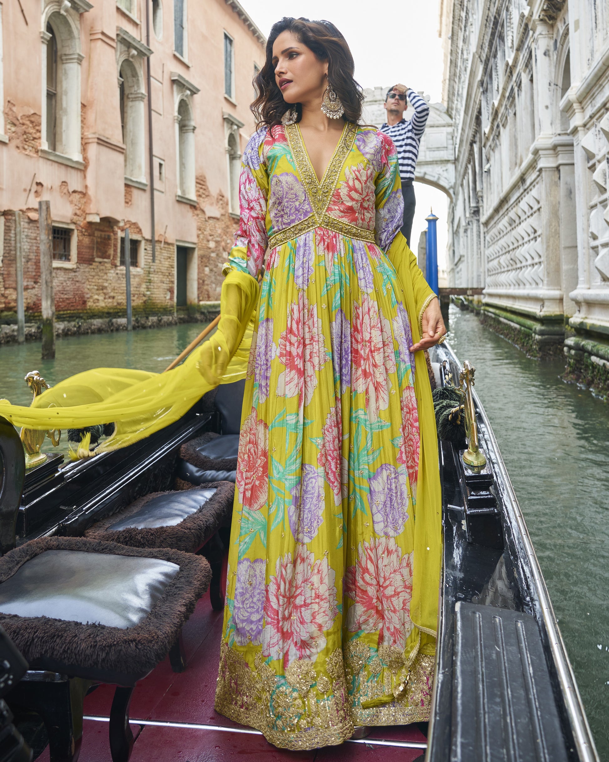 Woman in a colorful dress on a gondola in Venice