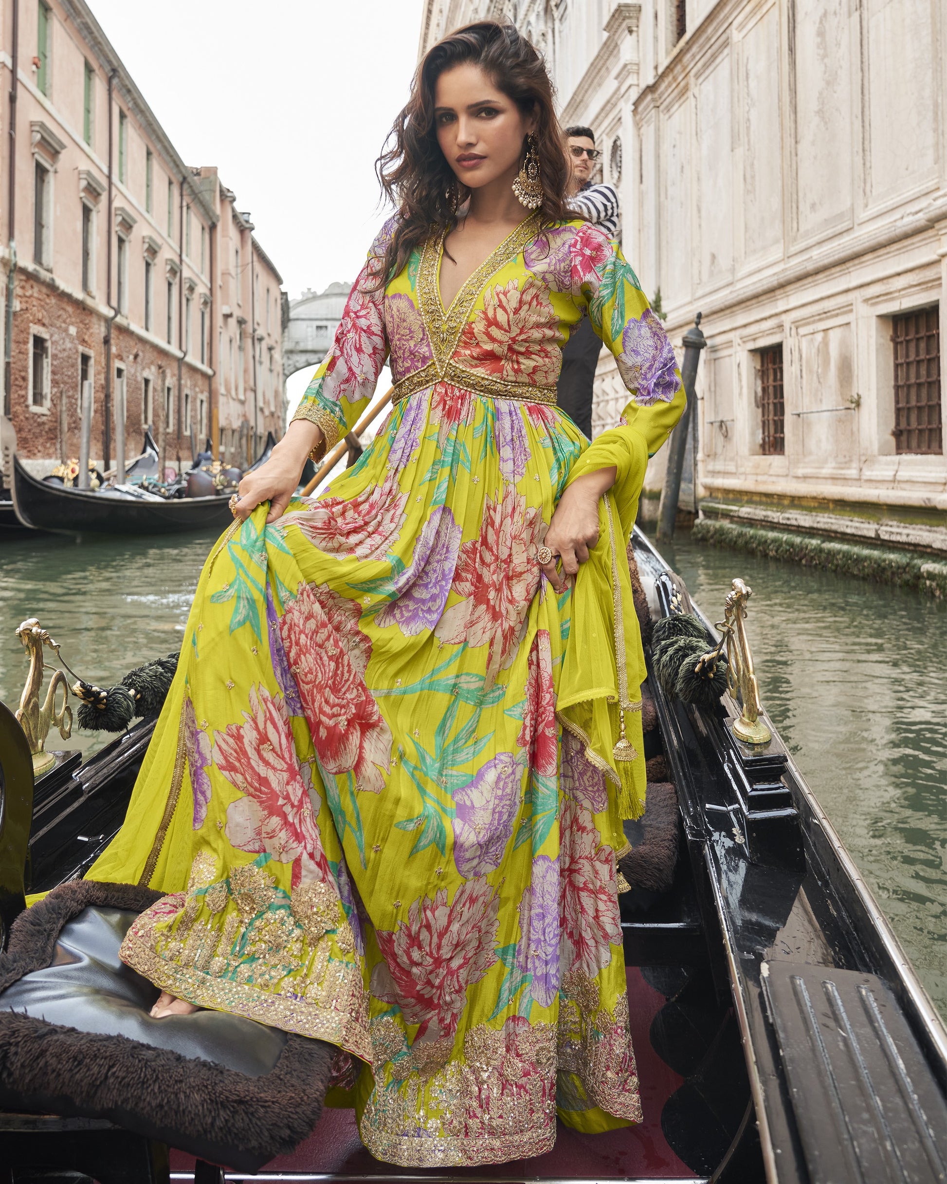 Woman in a colorful dress on a gondola in Venice