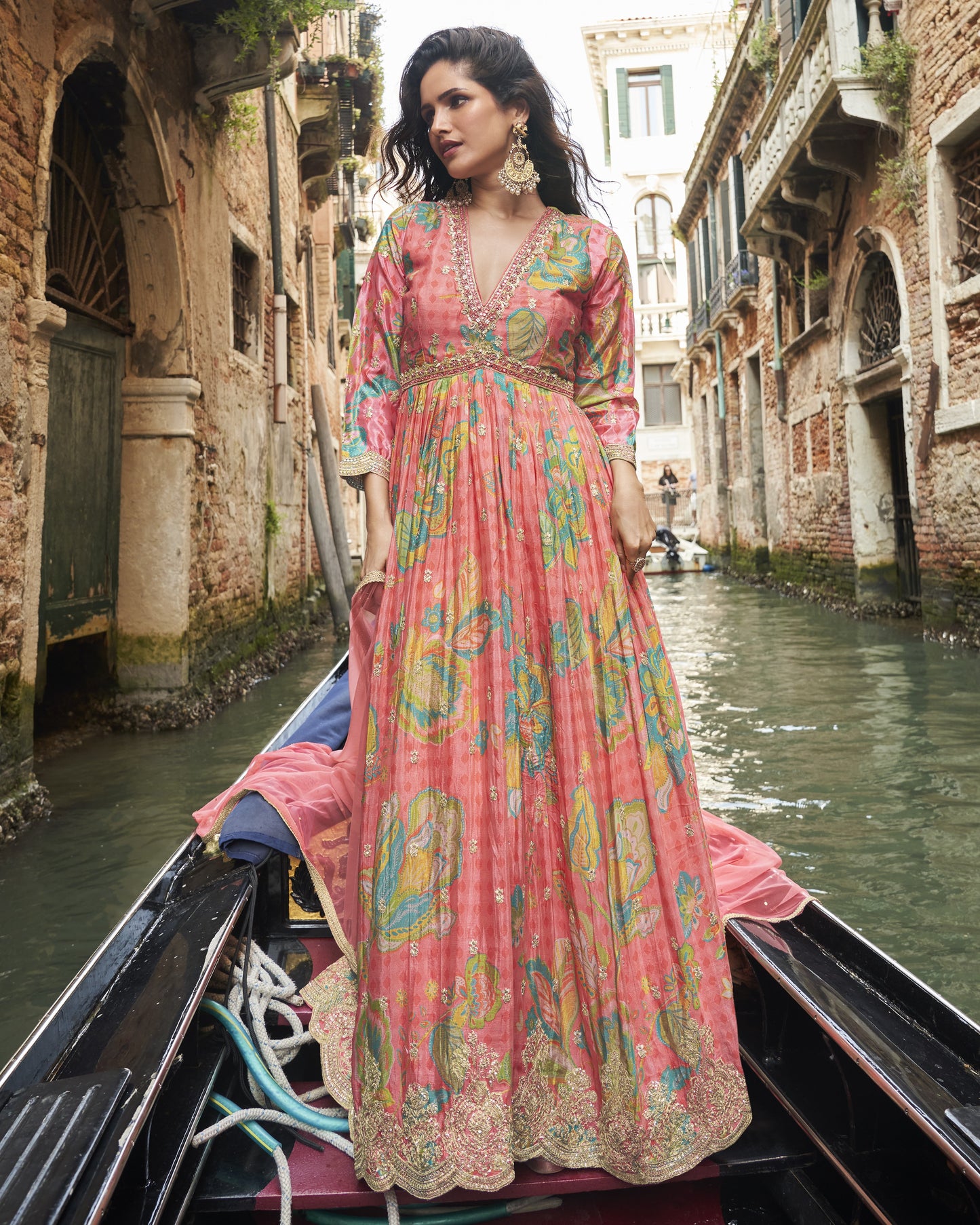 Woman in a colorful dress on a gondola in Venice