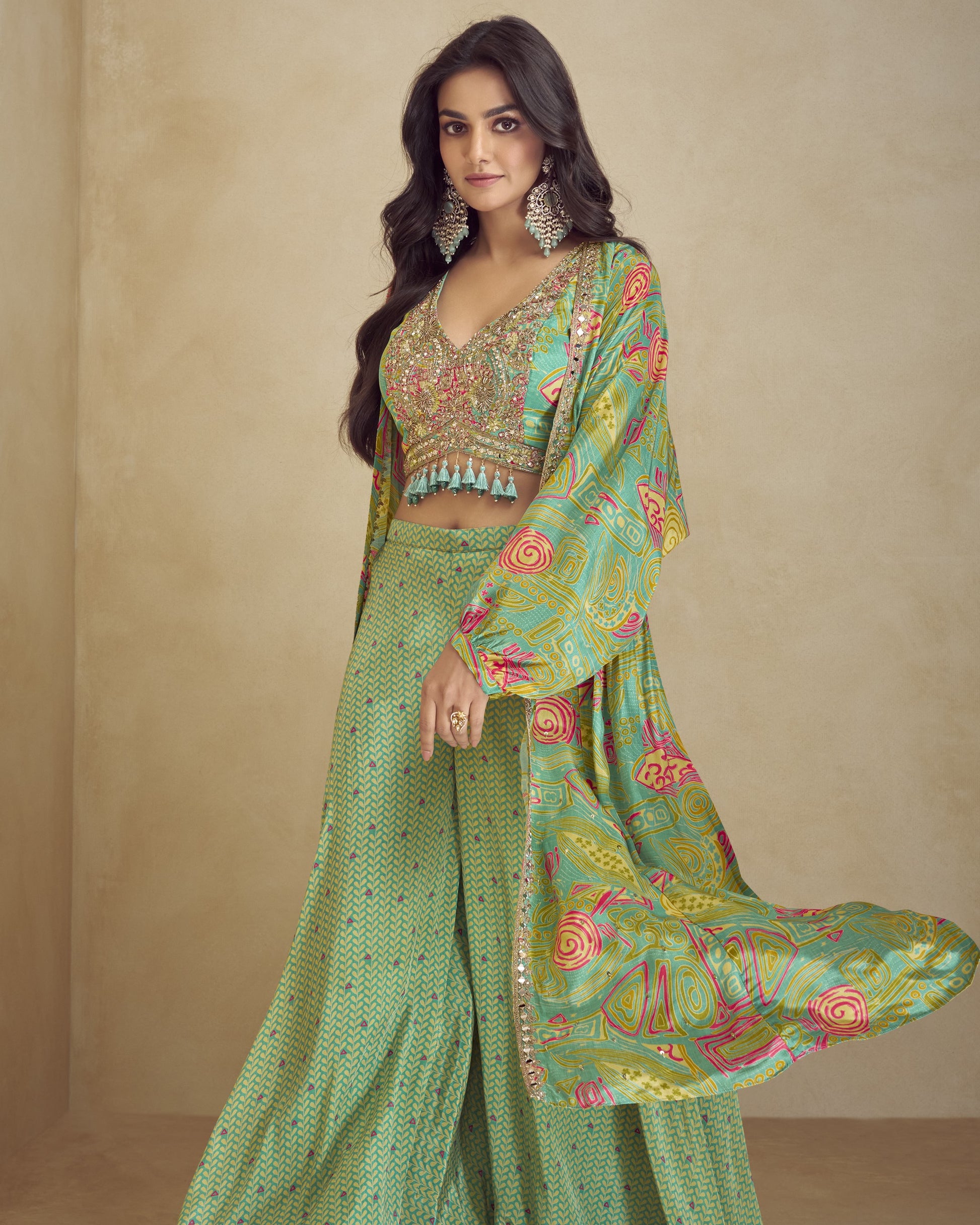 Woman wearing a green traditional outfit with floral patterns on a beige background