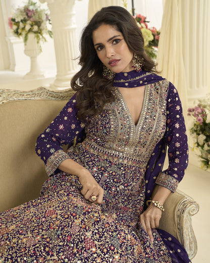 Woman in a floral dress sitting on a couch with decorative background