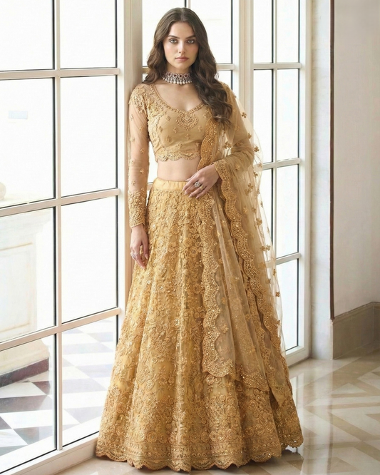 Woman wearing a gold lace outfit standing in a room with large windows.