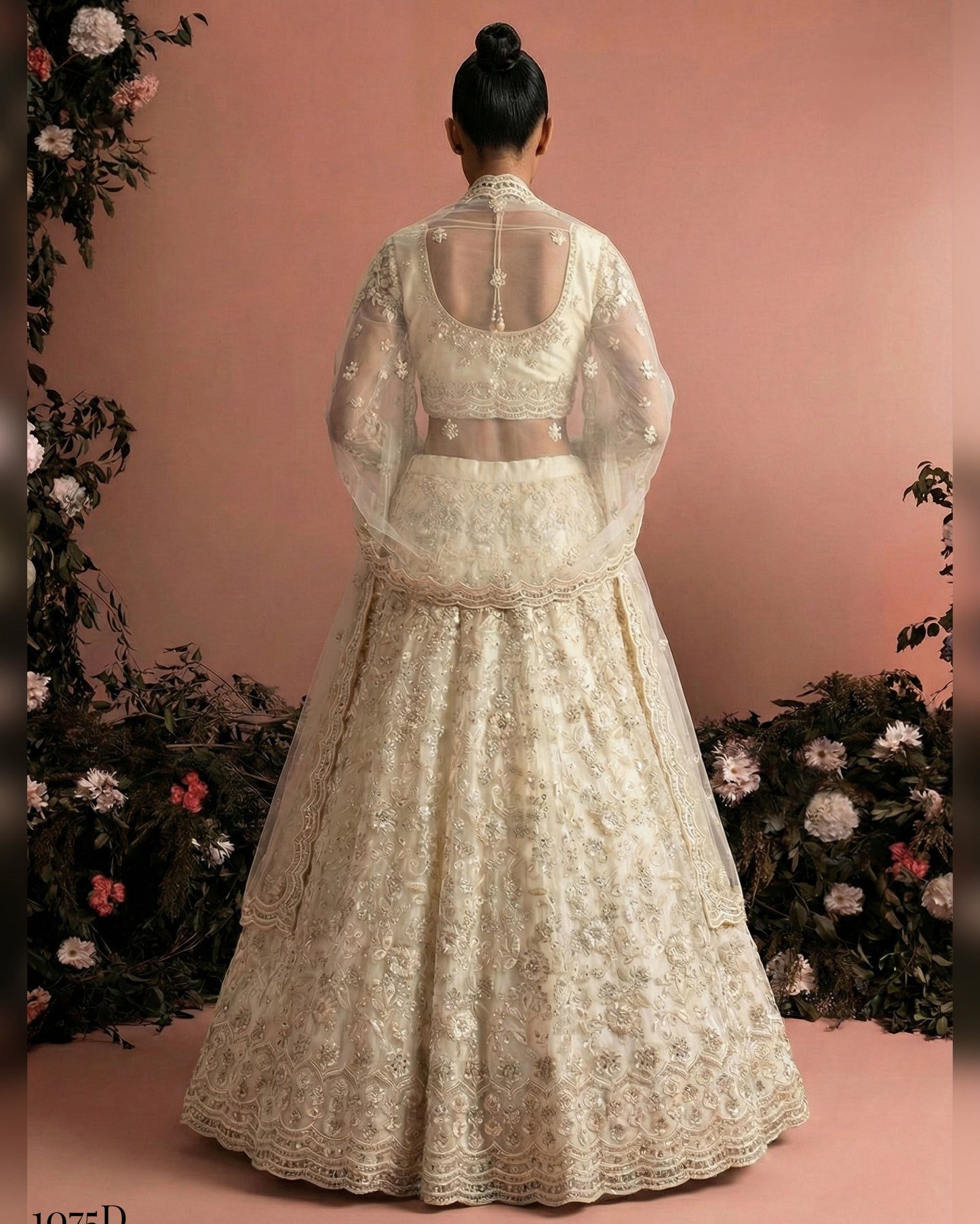 White embroidered traditional outfit with a sheer overlay on a pink background