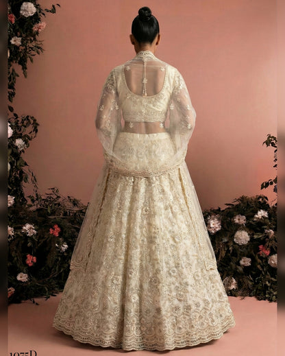 White embroidered traditional outfit with a sheer overlay on a pink background