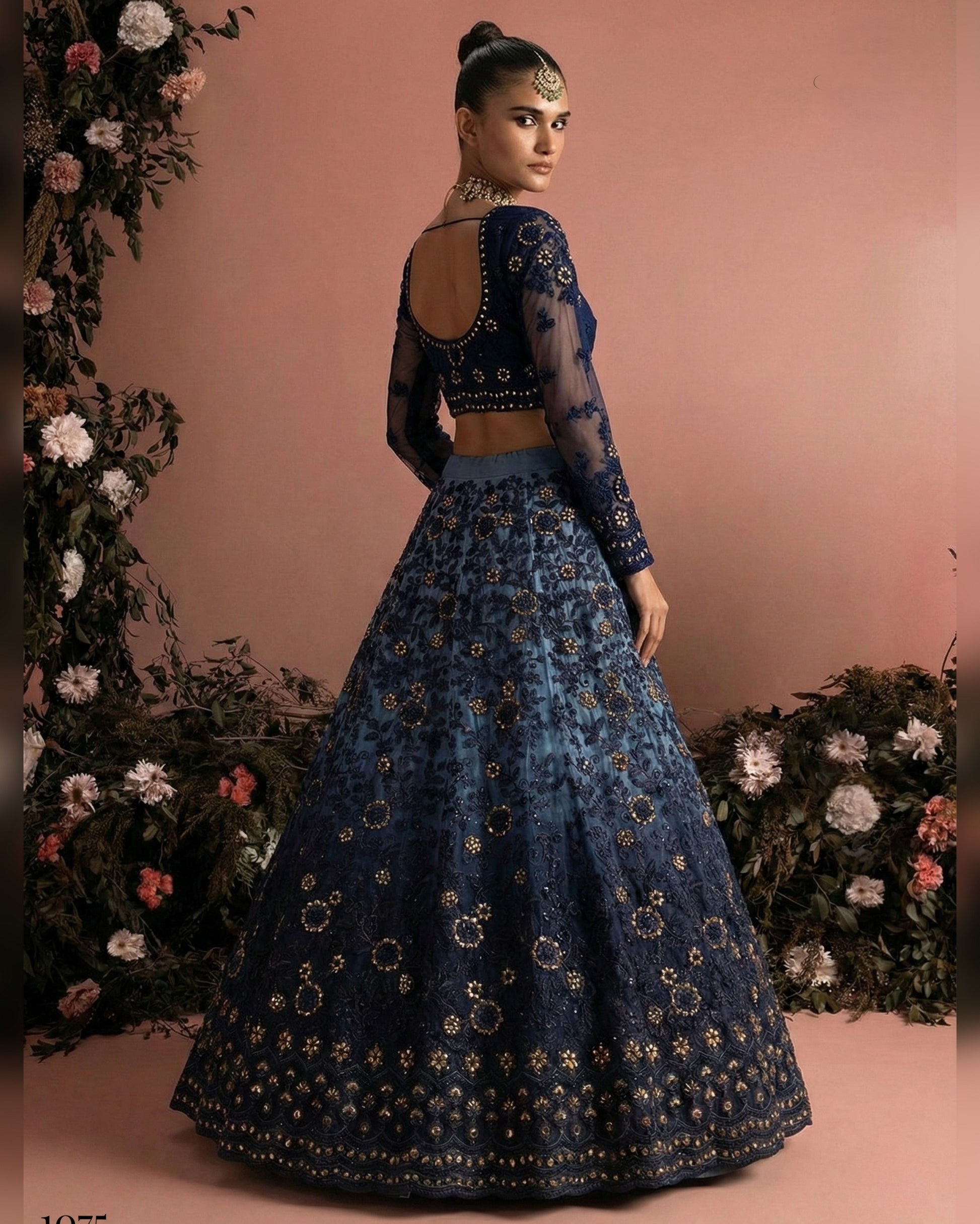 Woman wearing a blue embroidered traditional outfit with a floral background