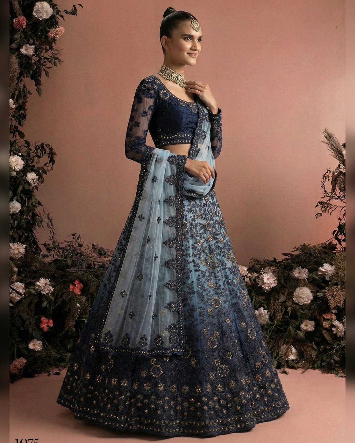 Woman wearing a traditional blue and black embroidered outfit with a floral background