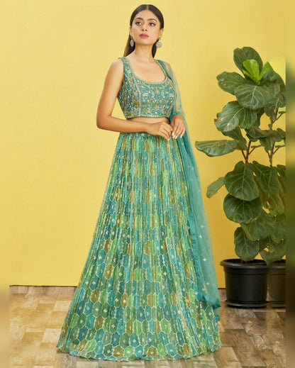 Woman wearing a green and blue patterned outfit with a yellow background
