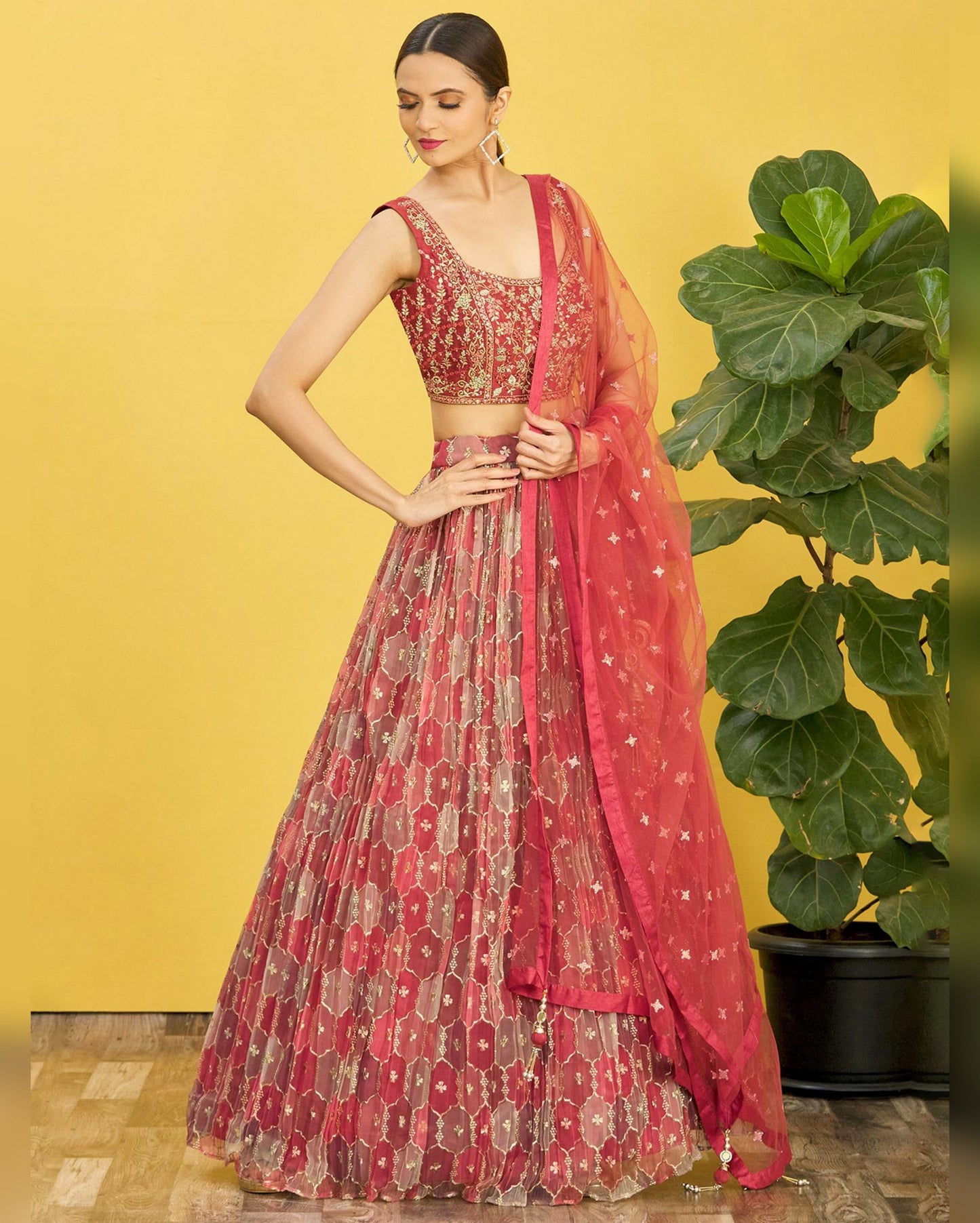 Woman wearing a red and gold traditional outfit with a yellow background