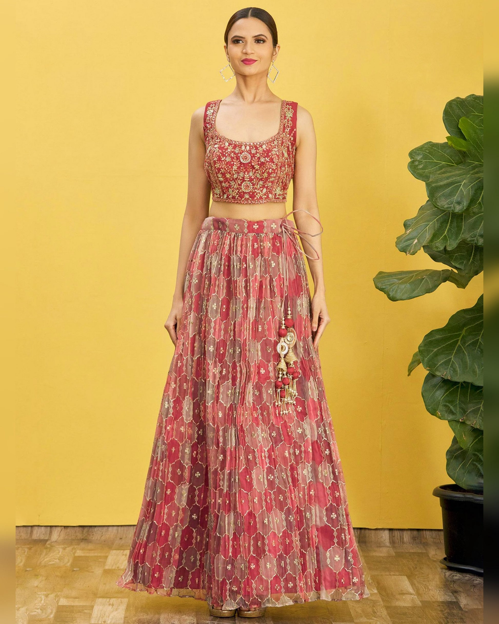 Woman wearing a red floral dress against a yellow background