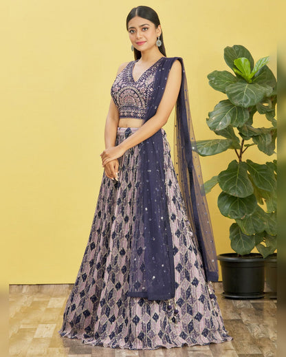 Woman in a traditional outfit with a yellow background and plant
