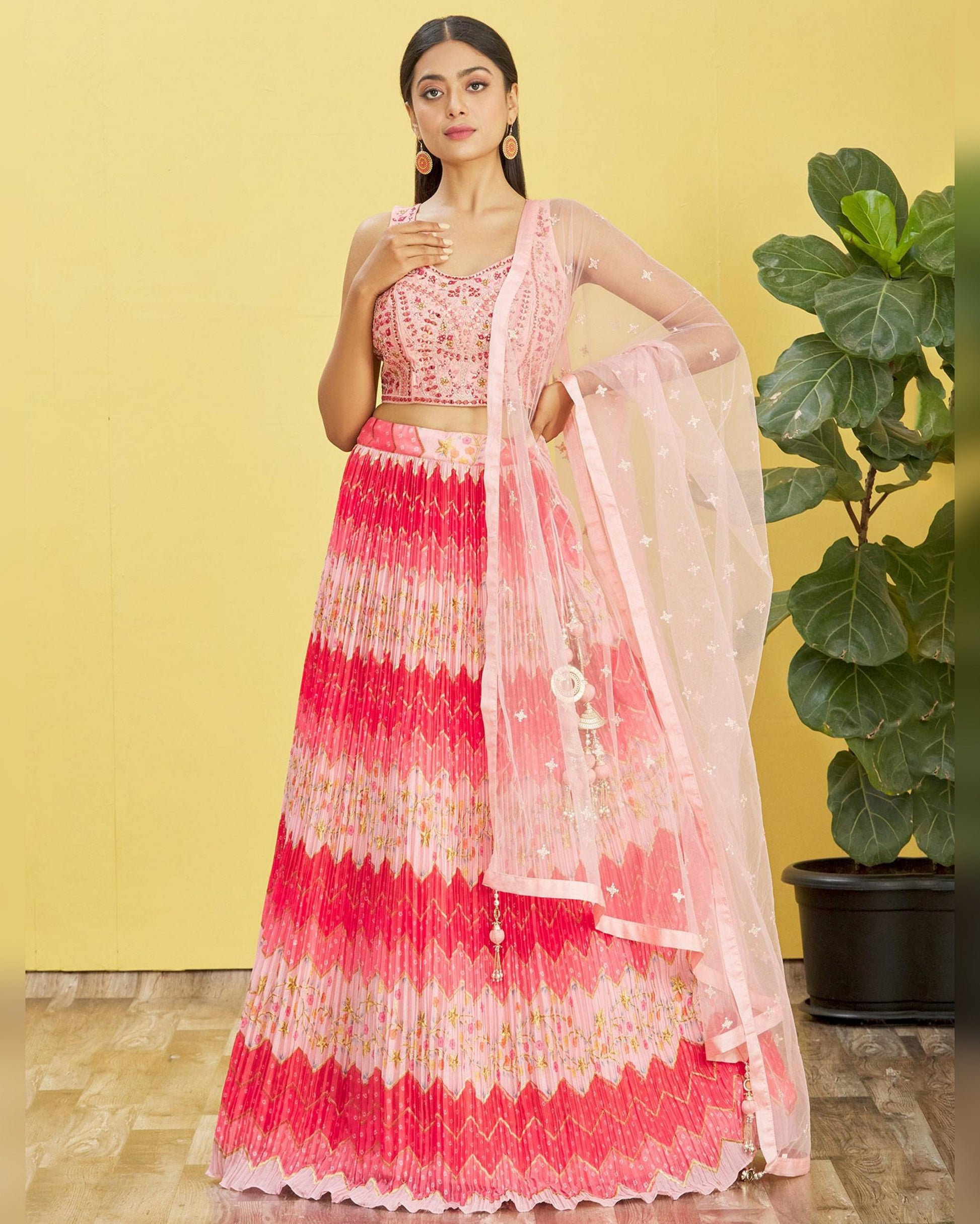 Woman wearing a pink and white traditional outfit with a yellow background
