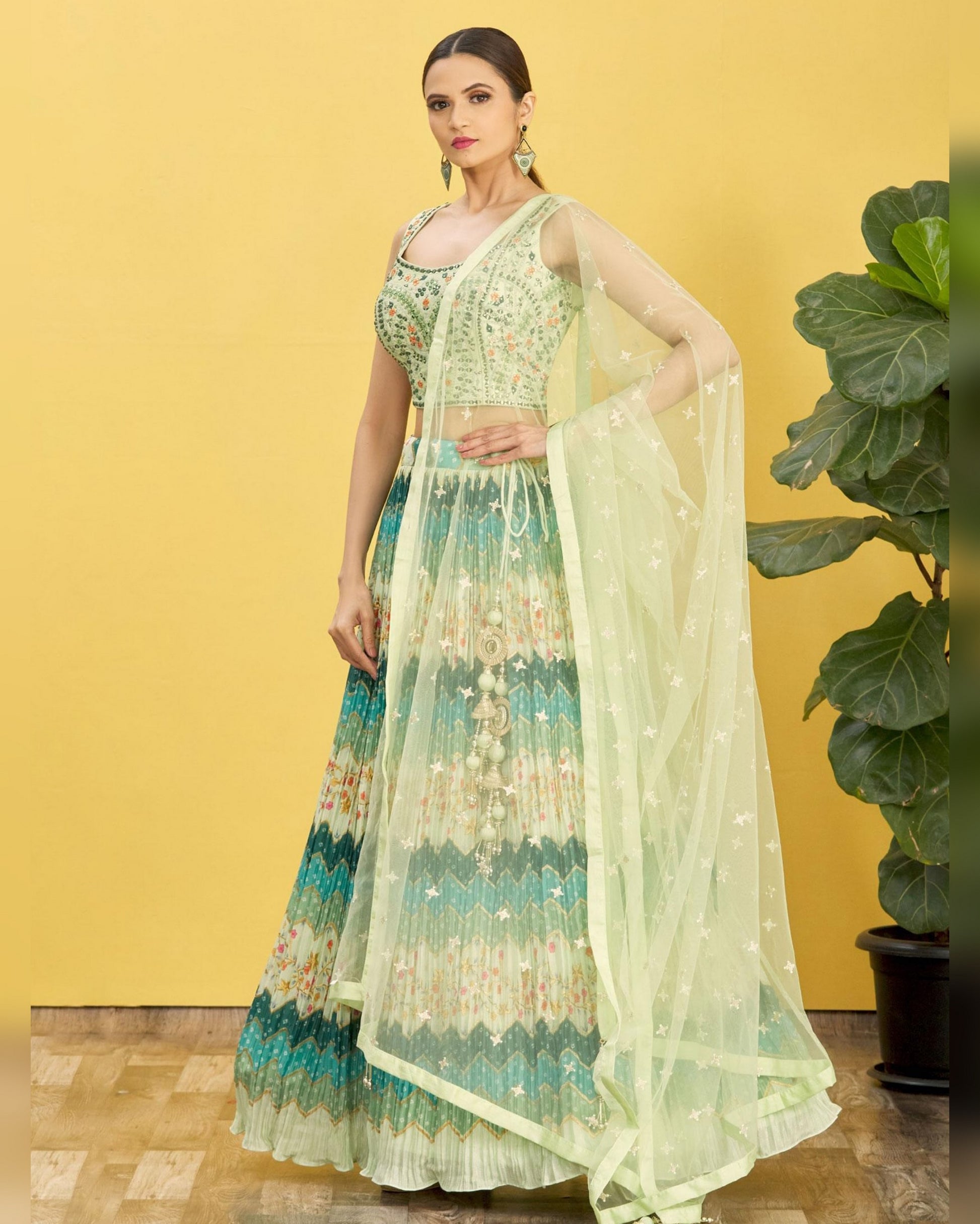Woman in a floral anarkali suit with a yellow background