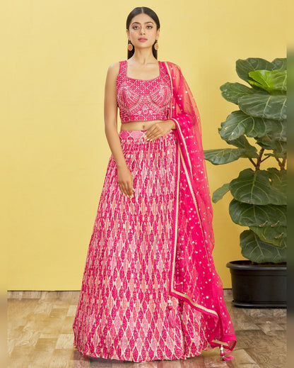 Woman wearing a pink and white patterned traditional outfit with a yellow background
