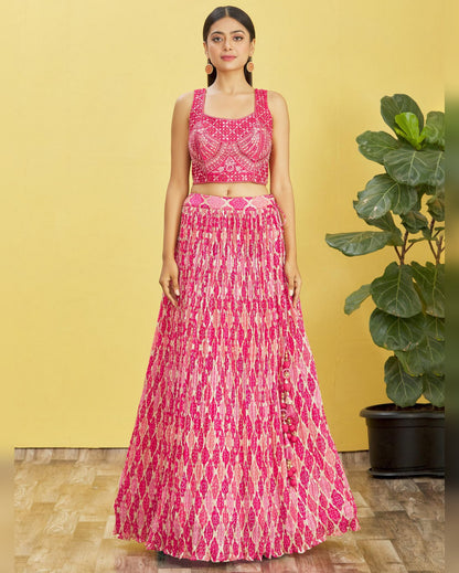 Woman wearing a pink patterned outfit with a yellow background