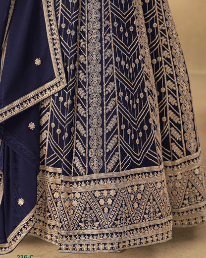 Navy blue fabric with intricate gold embroidery on a beige background