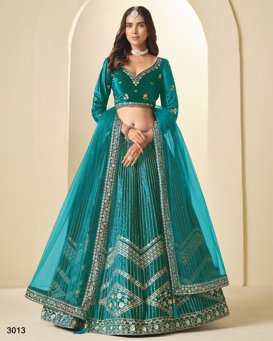 Teal embroidered lehenga with matching blouse against a beige background