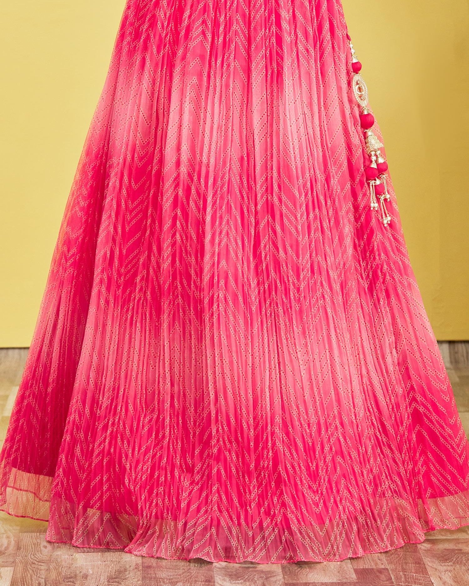 Pink pleated fabric with decorative elements on a yellow background