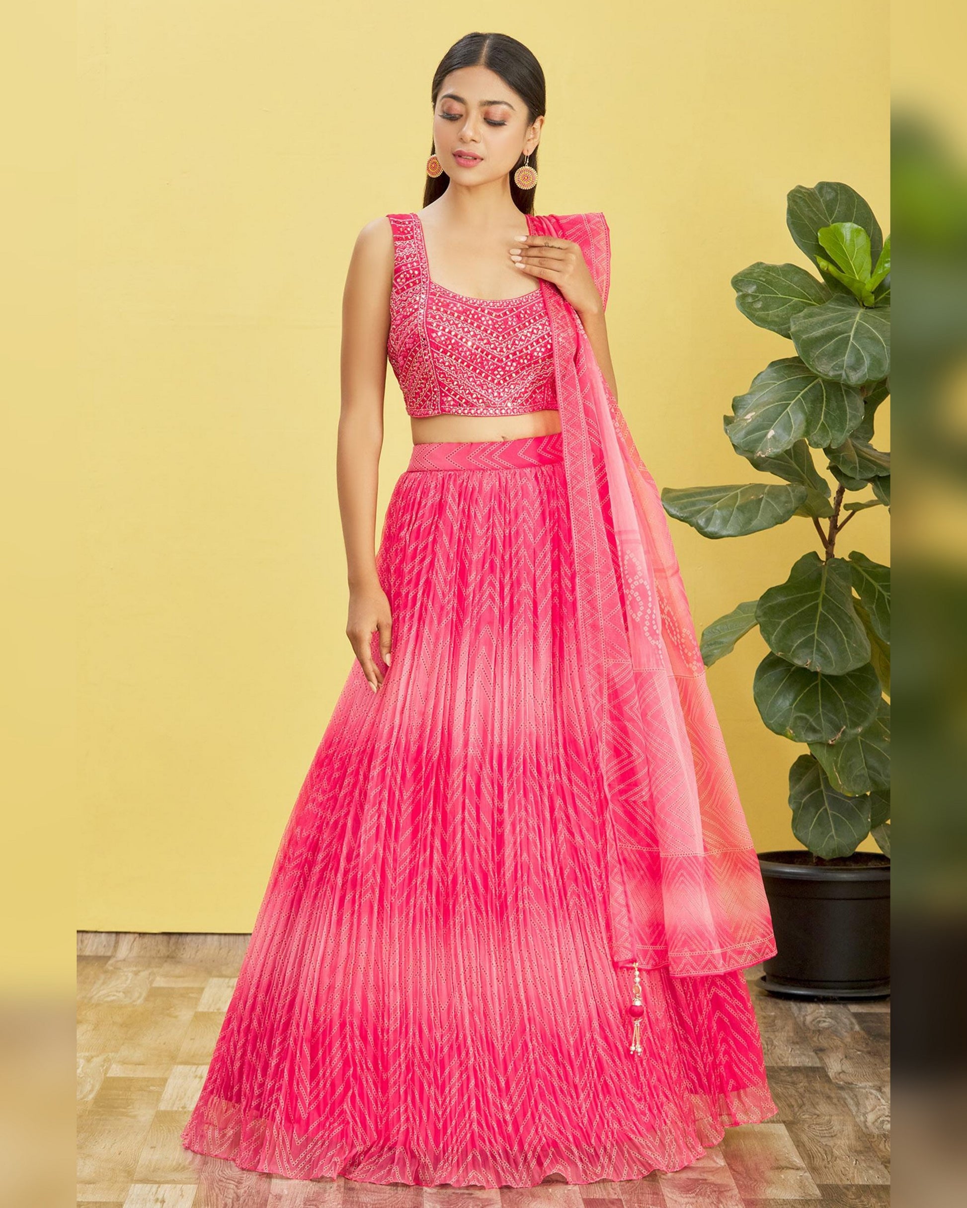 Woman wearing a pink traditional outfit with a yellow background