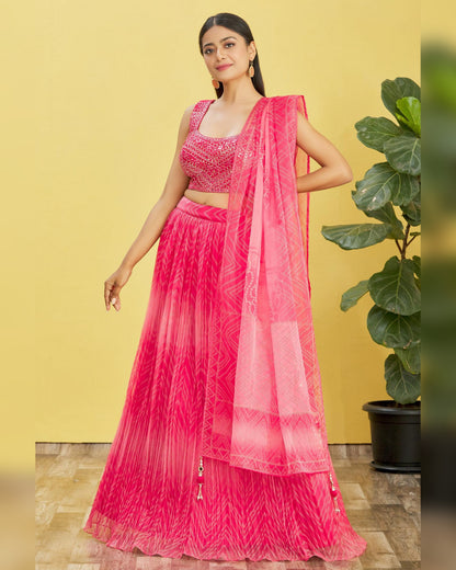 Woman wearing a bright pink traditional outfit with a yellow background