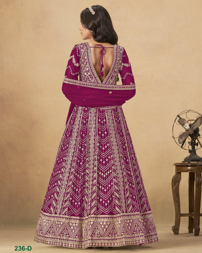 Woman wearing a purple and white patterned dress against a beige background