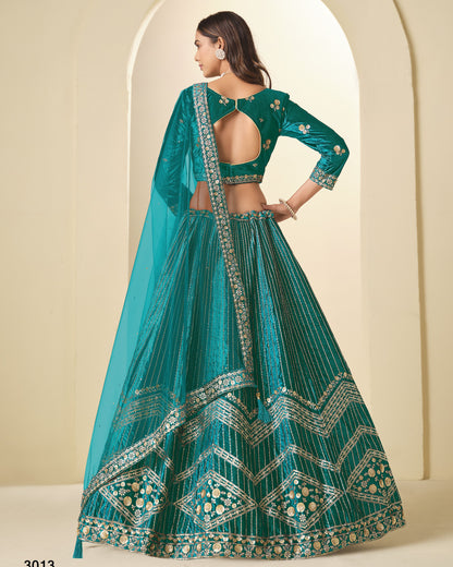 Teal embroidered traditional outfit with a plain background