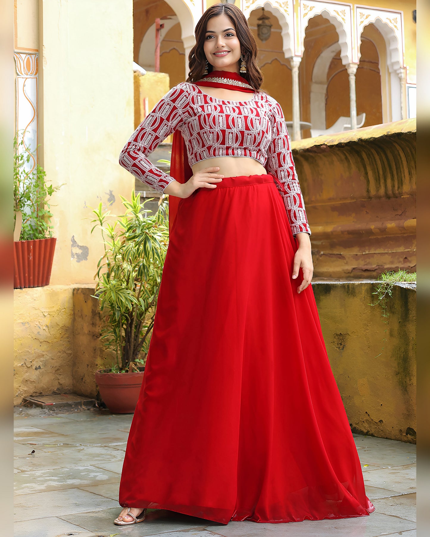 Woman wearing a red and white traditional outfit with a yellow architectural background